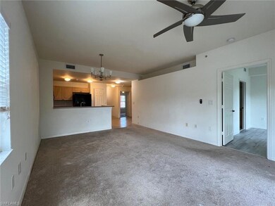 Unfurnished living room with dark carpet and ceili