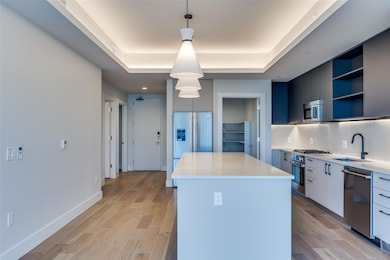 Kitchen featuring a kitchen island, pendant lighti