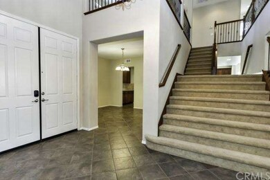 Welcoming Entry Dual sided staircase with wrought 