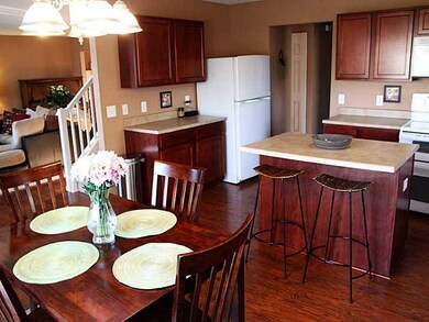 Kitchen. Breakfast Area attached to kitchen with large center island. Views from the kitchen/Breakfast Area extend to family room and back patio.