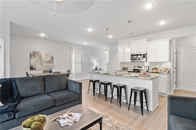 Living room with baseboards, recessed lighting, vi