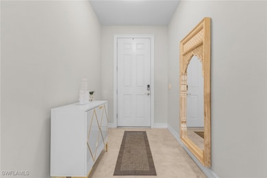 Doorway with light tile patterned floors
