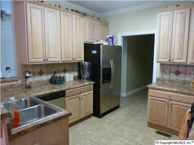 KITCHEN OFFERS LOTS OF CABINET SPACE AND OPENS TO BREAKFAST AREA