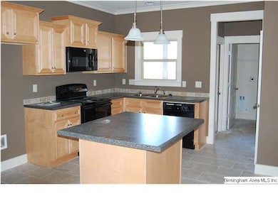 Generous size kitchen island, tile floors.
