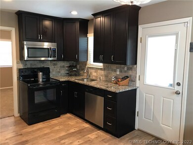 The door opens into the kitchen. Granite counter t