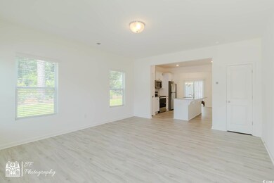 Empty room featuring baseboards, a chandelier, and