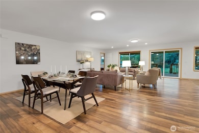 open concept common area staged with dining and living area