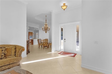 Tiled foyer entrance featuring ornamental molding 