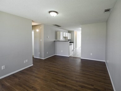 Unfurnished room with baseboards, visible vents, a