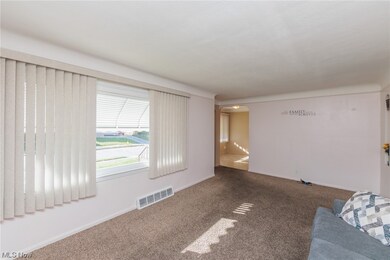 Spare room featuring dark colored carpet