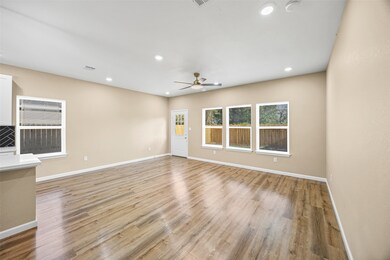 The spacious living area offers the perfect setting for both casual meals and special gatherings, effortlessly connecting to the kitchen and dining areas for easy, open-concept entertaining.