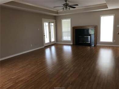 Unfurnished living room featuring a raised ceiling