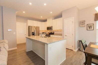 Kitchen featuring backsplash, light hardwood floor