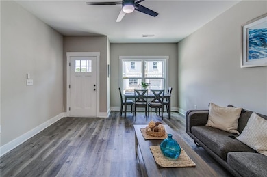 Living room with ceiling fan, wood finished floors