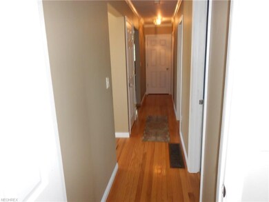 Living room leads to hallway and breaks off to the