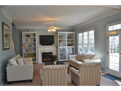 Family room with crown molding, fireplace, built-i