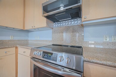 Modern kitchen with stainless steel appliances, sl