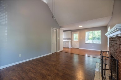 Vaulted ceilings give the great room a feeling of spaciousness.  Newer wood laminate floors are a nice bonus!