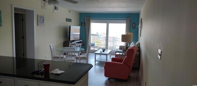 Living area with wood finished floors and ceiling 