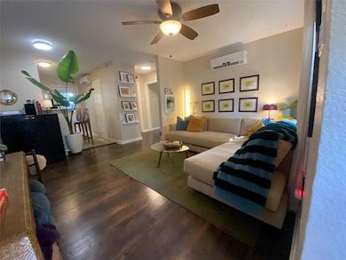 Living area featuring dark wood-style floors, a c
