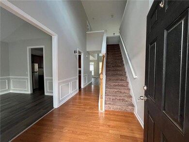 Entrance foyer with light hardwood / wood-style fl