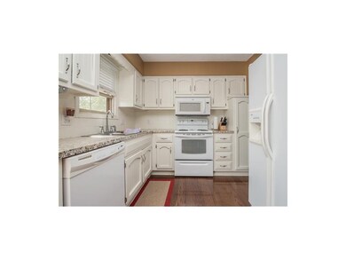 Bright White Kitchen With Wood Floors