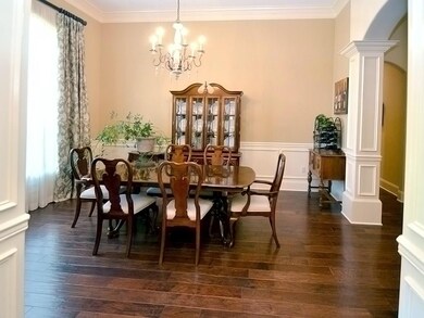 Bright and open dining room with custom drapes by 