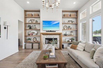 Living room with a fireplace, light hardwood / woo