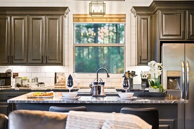 Kitchen featuring stainless steel fridge with ice 