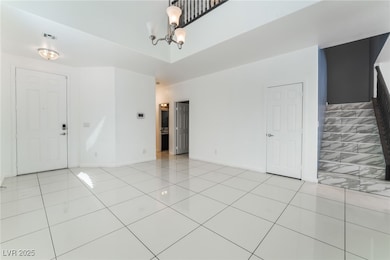 Foyer entrance with a chandelier, visible vents, b