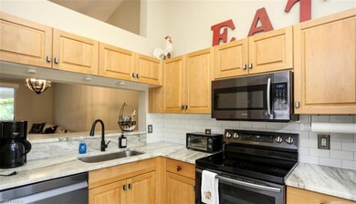 Kitchen featuring sink, light brown cabinets, back