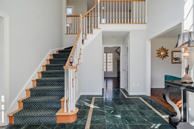 The welcoming 2-story foyer