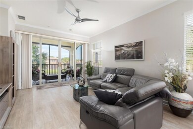 Living room featuring crown molding, ceiling fan, 