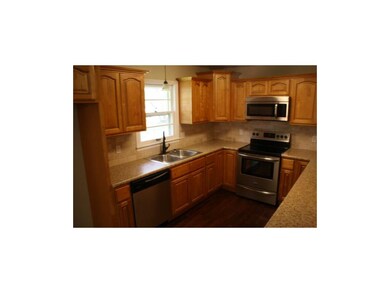 Travertine Backsplash and Stainless Steel Applianc