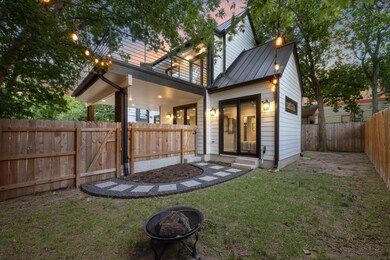 Rear view of house featuring a standing seam roof