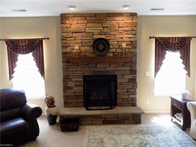 Family room with stone gas fireplace.