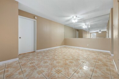 Bright room with beige walls and tiled floors, fea