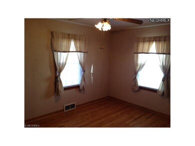 The back bedroom also features hardwood flooring, 