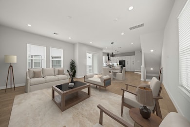 The second floor living area is easily accessible from the staircase and shows the open-concept layout which effortlessly connects the family room, dining area and kitchen making it ideal for both everyday living and entertaining. This room has been virtually staged.