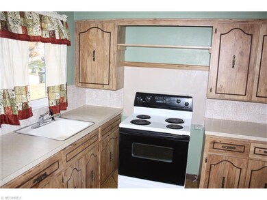Kitchen includes range and refrigerator.