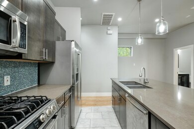 Kitchen with stainless steel appliances, a sink, 
