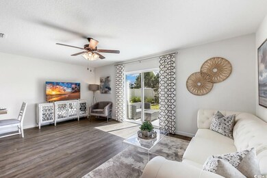Living room with wood finished floors and ceiling fan