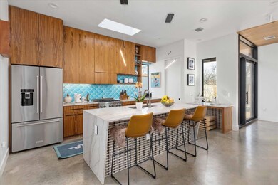 Kitchen featuring high end fridge, brown cabinets