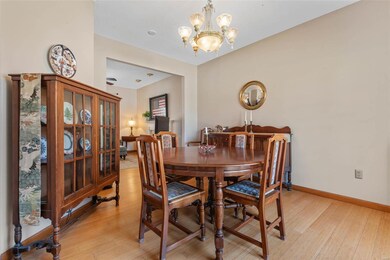 Dining area featuring baseboards, light wood finished floors, and a chandelier
