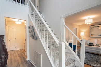 Staircase with wood finished floors, visible vents
