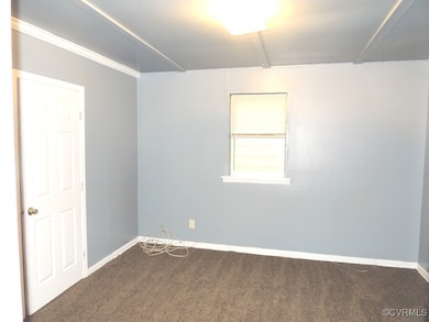 Empty room with carpet flooring and baseboards