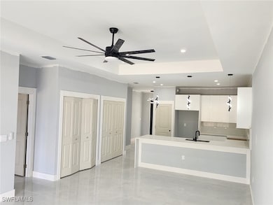 Kitchen featuring pendant lighting, sink, backspla