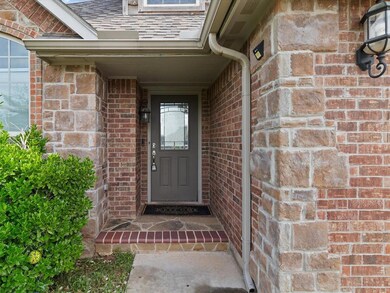 Doorway to property featuring brick siding