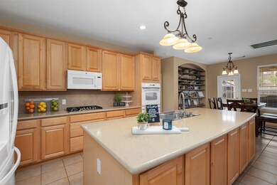 Can you say STORAGE?  This home has so much cabinet and counter space.  The breakfast bar has full cabinets across the front and there is also a closet under the stairs close by which is shelved for even more storage space.  The openness of the kitchen to the family room makes for such a great space.