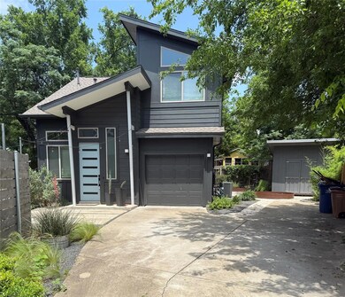 Contemporary home with concrete driveway, a garag